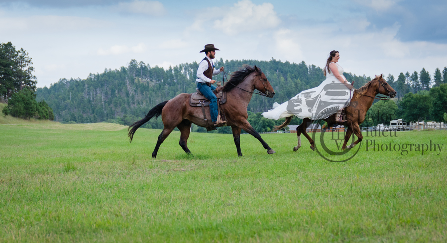 Newly weds riding horses at their wedding